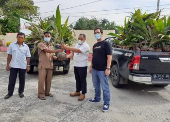 Jr.Env. Control & Measuring officer Health Safety Environment (SHE) PT Semen Padang Alif Yuza (dua dari kanan) menyerahkan bibit kelapa dalam kepada Plt Kabid Perkebunan Dinas Pertanian Kabupaten Dharmasraya Ijhon.