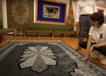 Nikita Mirzani melihat karpet yang akan dibelinya