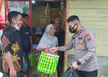 Ipda Novit Kosmiko didampingi Wawako Solok, Ramadhani Kirana Putra menyerahkan bantuan sembako pada masyarakat membutuhkan di Kota Solok