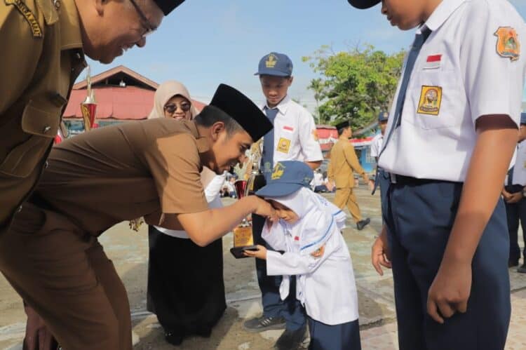 Wawako Solok, Ramadhani Kirana Putra menyerahkan trophy kepada salah seorang siswi berprestasi di SMP N 2 Kota Solok.(Prokomp)