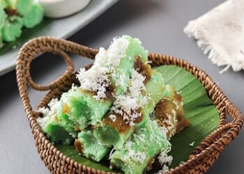 putu cake or kue putu ayu, a cake filled with palm sugar, covered with grated coconut, and coarse-grained rice flour. steamed by placing it in a slightly compacted bamboo tube