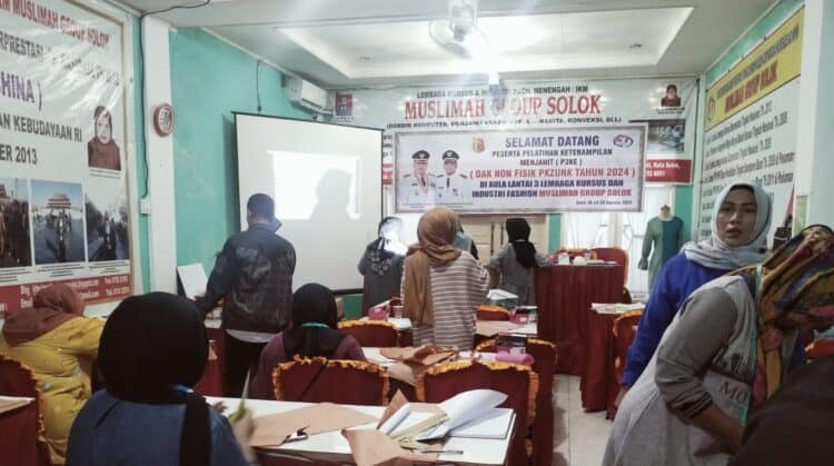 Serius, 25 peserta pelatihan menjahit DPKUKM Kota Solok melakukan praktek di LKP Muslimah Group.(Ist)